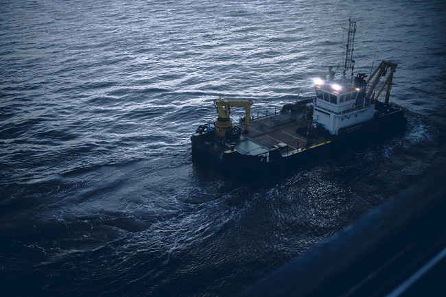 Photo of ship in ocean at nighttime