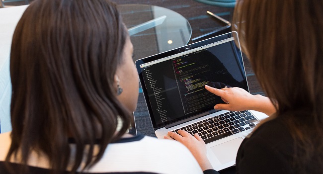 Two colleagues discussing data