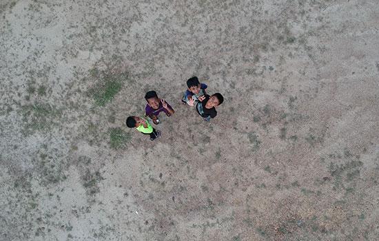 Aerial image of children waving