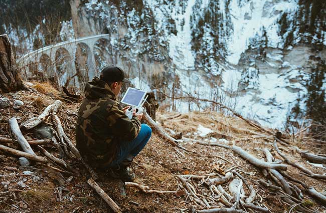Forestry-worker-using-drone