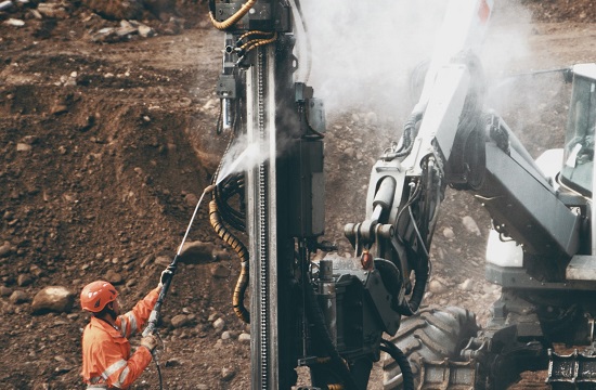Worker cleaning mining equipment