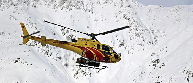 Helicopter in snowy mountains