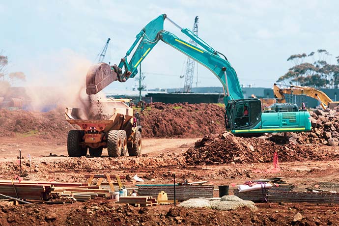 Digger filling soil in to Dumper Truck