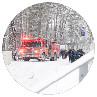 Fire truck in snow with first responders circle